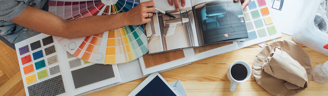 Color wheels and design magazines spread out on table 